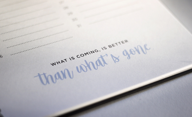 Notebook with the words "what is coming is better that what's gone"